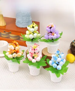 Close-up of five colorful Easter egg plants in white diamond textured pots on a tablecloth