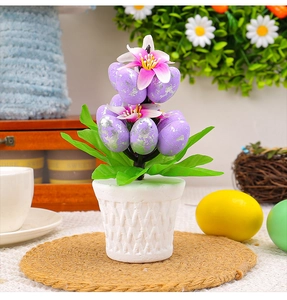 Close-up of Easter flower pot with purple silver-foil eggs and green leaf details