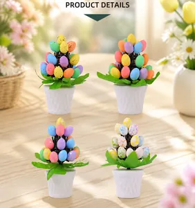Detail of four colorful spotted Easter egg potted plants with green leaves and white pots