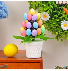 Detail of colorful speckled Easter egg tree in a white woven flower pot on a wooden desk