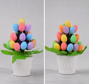 Close-up of Easter egg bonsai with colorful speckled eggs in a white textured pot