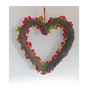 Back view detail of heart-shaped grapevine wreath with red roses and green leaves