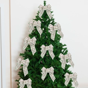 Set of 10 red and green plaid linen bows decorating a green Christmas tree for holiday decor