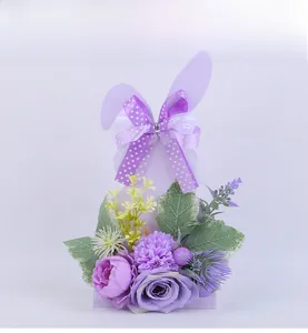 Detail of purple rabbit centerpiece featuring silk roses and dotted ribbon bow decor