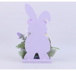 Detailed view of wooden Easter bunny figurine with lavender floral accents and a solid base