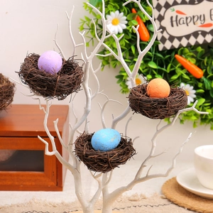 Easter bird nest set with colorful speckled eggs on white decorative branch base