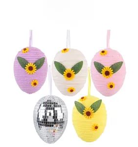 Detailed view of knitted Easter egg ornaments with sunflower decor and disco mirror egg