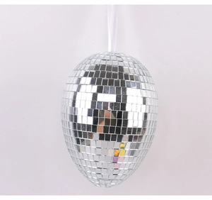 Close-up of a silver mirror disco ball Easter egg with a white hanging ribbon detail
