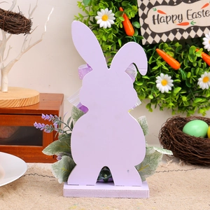 Easter lavender wood bunny ornament with ribbon bow and faux flowers on desk