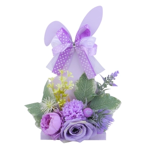 Purple Easter bunny decoration with faux flowers and polka dot ribbon on a white base