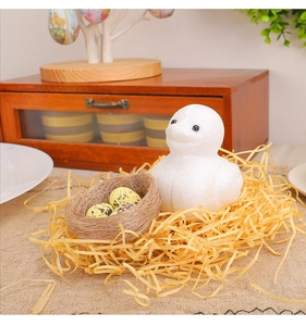 Detailed close-up of a white glitter Easter chick ornament with nest and speckled eggs