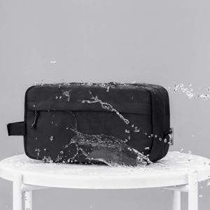 Waterproof black nylon toiletry bag with double zippers and side handle for travel storage