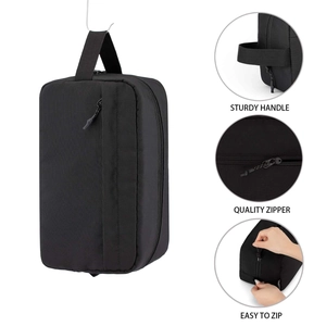 Portable black toiletry travel bag with sturdy handle and smooth metal zipper details