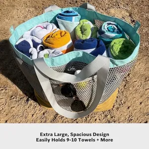 Extra large mesh beach bag in mint and yellow holding multiple colorful rolled towels