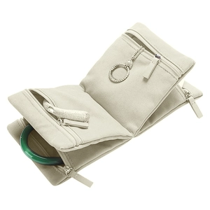 Detailed top-down view of beige travel jewelry organizer with multiple zipper pockets