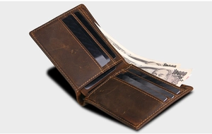 Macro shot of dark brown crazy horse leather wallet showing multiple card slots and bill pocket