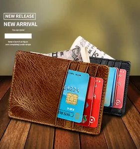 Close-up of slim oil wax leather card holders in brown and black on wood background