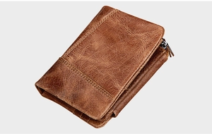 Macro shot of brown crazy horse leather wallet showing texture and metal zipper