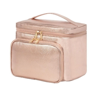 Detail view of large rose gold PU cosmetic bag with smooth golden zippers and top handle