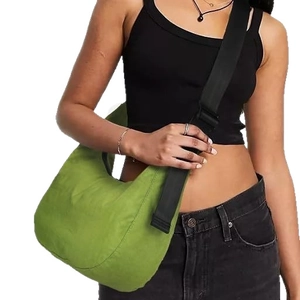 Minimalist green crescent crossbody shoulder bag with adjustable black fabric strap
