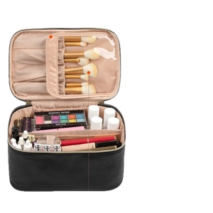 Large black leather makeup organizer with double zipper and brush slots in open view