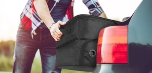 Action shot of a black honeycomb texture golf shoe bag being placed into a car trunk