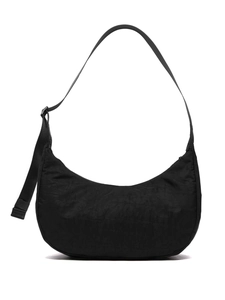 Minimalist black crescent shoulder bag with pleated texture and adjustable strap