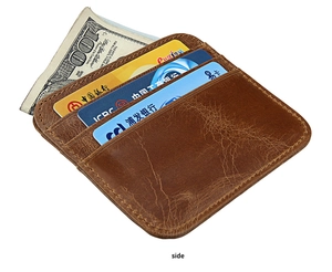 Macro detail of brown leather card holder featuring three card slots and a cash compartment