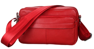 Detailed view of red pebble leather crossbody bag featuring multiple zipper compartments