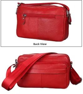 Detailed back view of red leather crossbody bag featuring functional zipper pockets