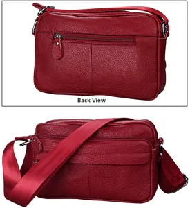 Detail view of the deep red cowhide leather bag back with metal zipper and strap