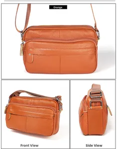 Macro detail of orange leather crossbody bag showing litchi texture and multiple zippers
