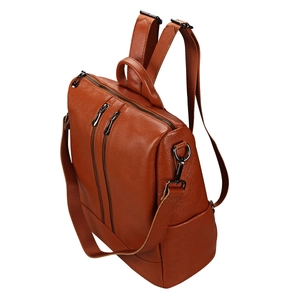 Gros plan du sac à dos en cuir marron ambre avec texture grainée et boucles métalliques