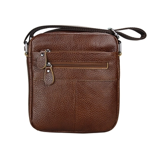 Detailed macro view of the brown pebbled leather texture and metal zipper pockets on the bag