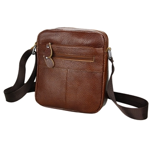 Detail of men's brown leather crossbody bag featuring lychee texture and front zipper