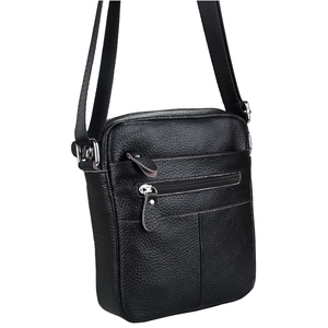 Close-up of black litchi grain leather texture on men's crossbody bag with silver zipper