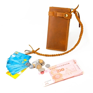 Detail view of a vintage long leather wallet with woven anti-lost lanyard and card slots