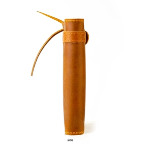Detailed side view of a vintage brown leather tool roll with a wrap-around cord closure