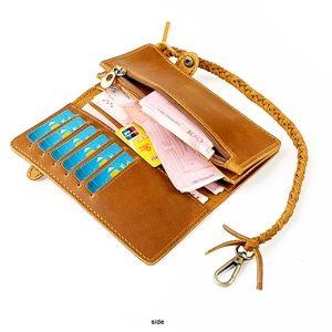 Brown genuine leather wallet detail showing internal card slots and anti-theft braided strap