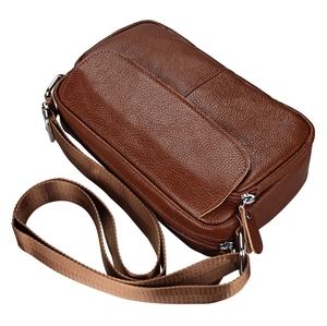 Detailed view of brown pebbled leather crossbody bag with multiple zipper compartments