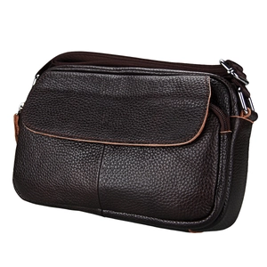 Detail of premium brown pebble leather crossbody bag showing texture and silver hardware