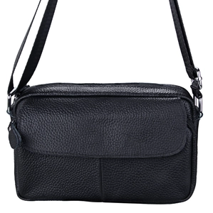 Detail of black lychee grain leather crossbody bag with silver buckles and adjustable strap