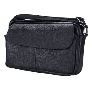 Close-up of litchi grain cowhide texture and silver metal buckle on black crossbody bag
