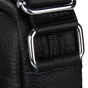 Detailed macro view of black lychee leather grain and silver metal adjustment buckle
