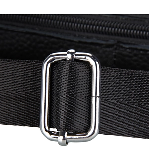 Close-up of adjustable black nylon strap with polished silver metal buckle on leather bag