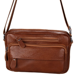 Macro detail of brown lychee grain leather crossbody bag with functional zip pockets