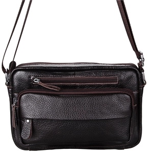 Close-up of dark brown leather crossbody bag with lychee texture and zipper pockets