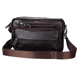 Detail of dark brown lychee textured leather crossbody bag with multi-zipper pockets