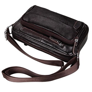 Close-up of deep brown leather shoulder bag with lychee grain texture and metal zippers