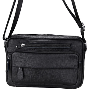 Detail of black litchi grain leather crossbody bag with multiple silver metal zippers